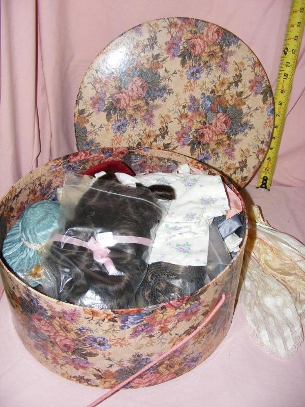 lot 10 image: Hat Box full of Doll items, clothes...