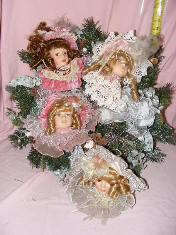 lot 107 image: Christmas Wreath with 4 doll heads...