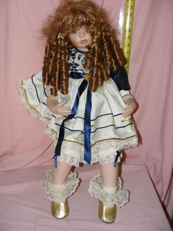 lot 163 image: Doll with curly brown locks of hair...