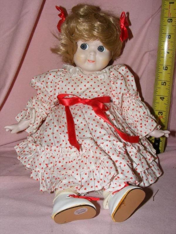 lot 176 image: Doll in red polka dotted dress...