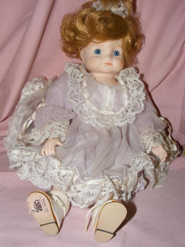 lot 186 image: Porcelain Doll, by Bradley Dolls...