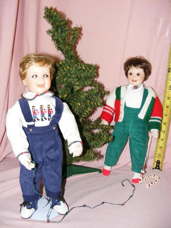 lot 25 image: Two Porcelain Boy Dolls, decorating...