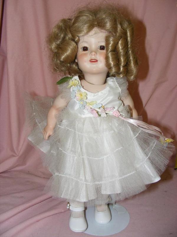 lot 41 image: Doll on stand, curly blonde hair...