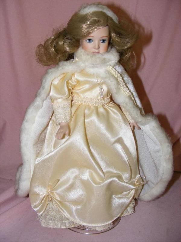 lot 54 image: Porcelain Doll on stand...