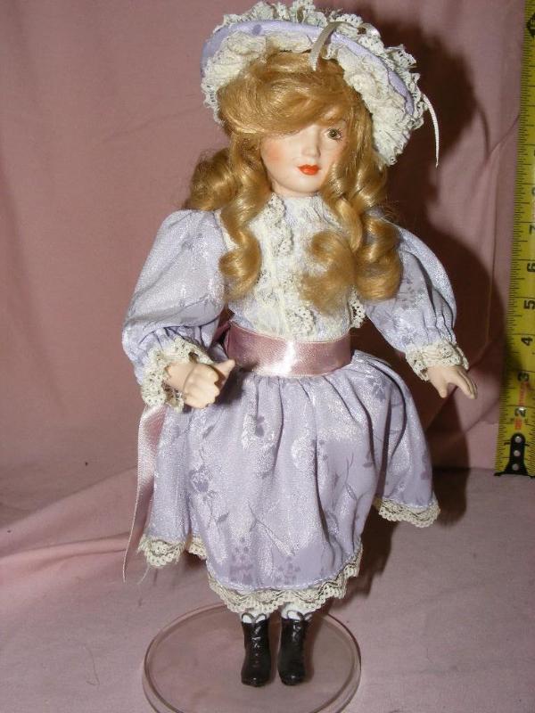 lot 59 image: Porcelain Doll, on stand Ligh...