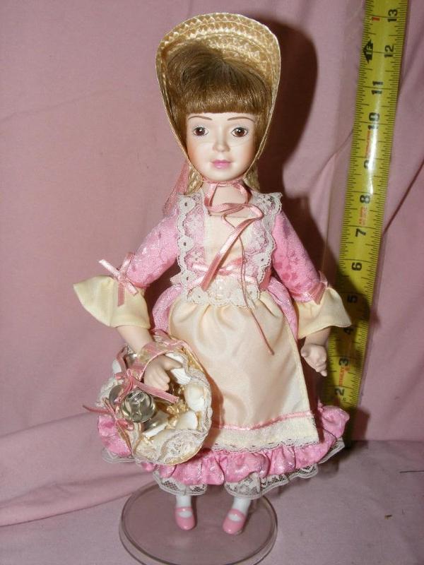 lot 60 image: Porcelain Doll, on stand. Pin...