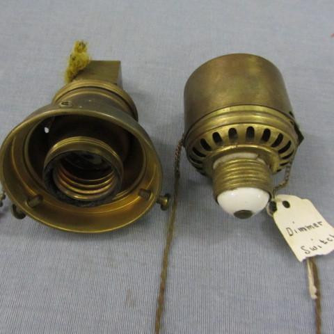 Brass electric lamp heads, one has ...