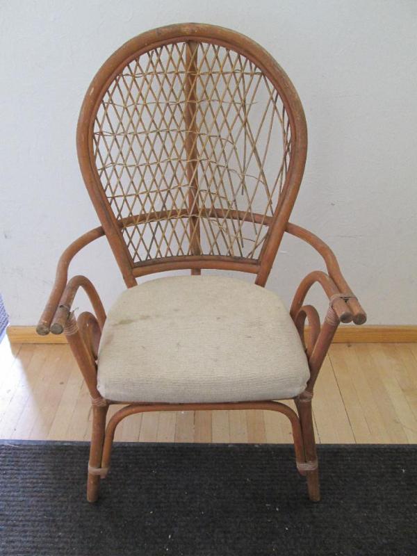 lot 163 image: Wicker chair with tan plush cushion...