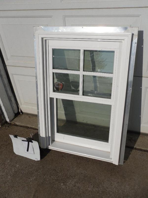 lot 7 image: New vinyl window with aluminum nail...