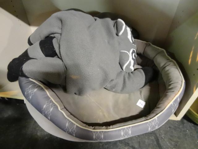 lot 96 image: Racoon pillow. Dog or cat bed...