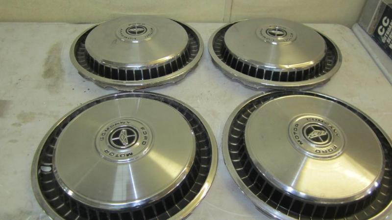 4 like new Ford hubcaps...