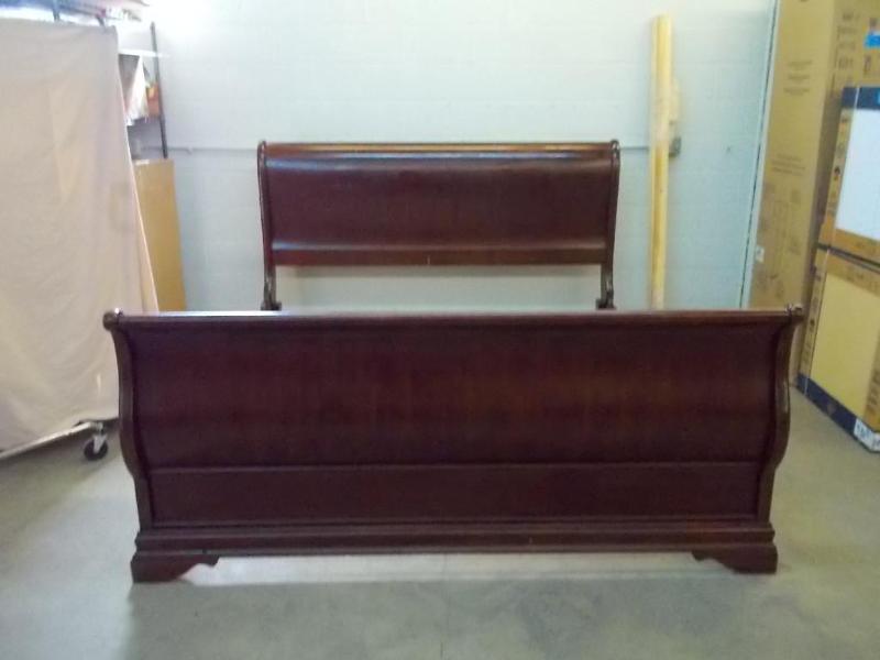 lot 28 image: Solid wood, dark finish sleigh bed....