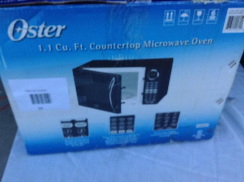 lot 10 image: Oster Microwave, new open box, fan ...