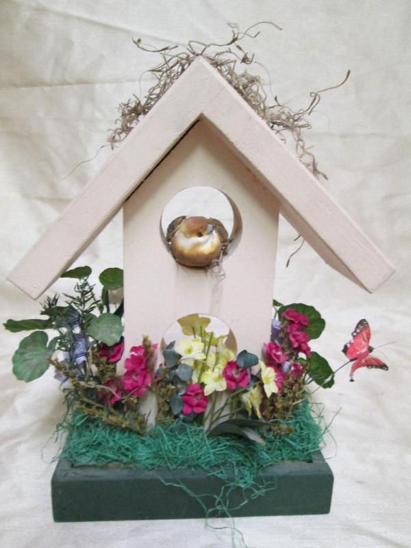 lot 127 image: Cute birdhouse with spring time flo...