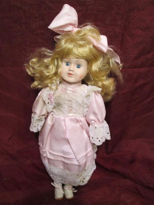 lot 183 image: Pretty porcelain doll in a satin pi...