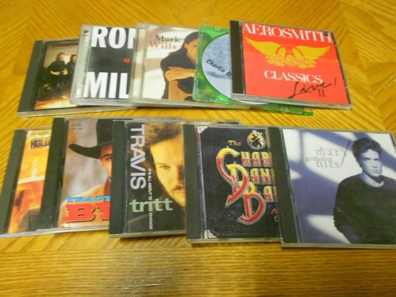 10 CDs from artist like Travis Tri...