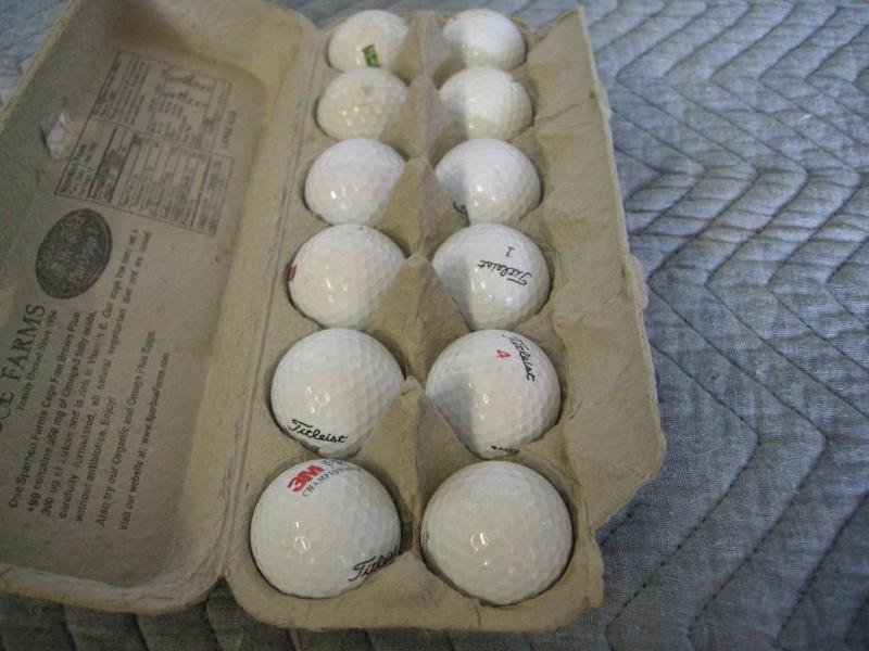 lot 96 image: 12 Titleist golf balls. Dusty but d...