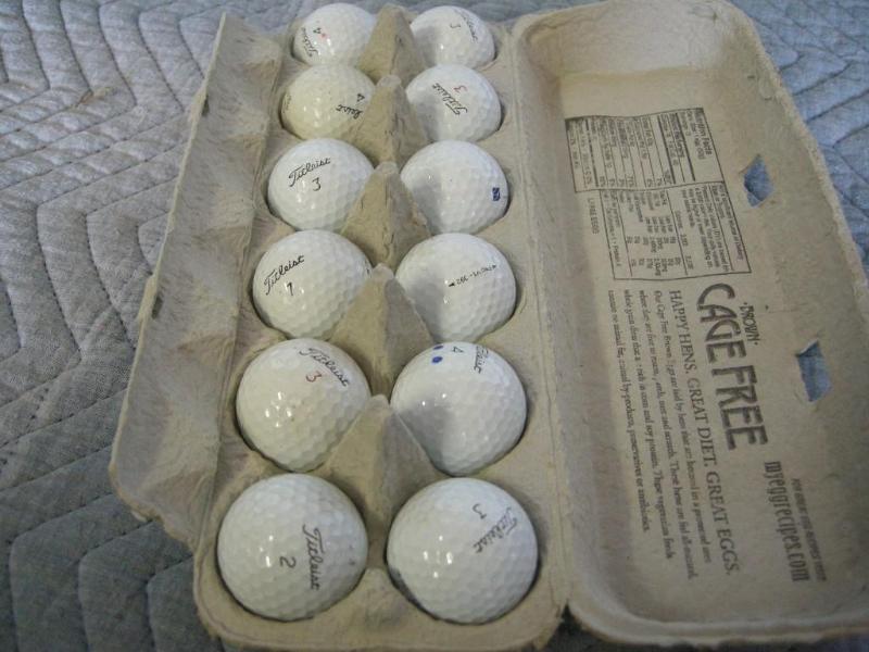 lot 98 image: 12 Titleist golf balls. Dusty but d...