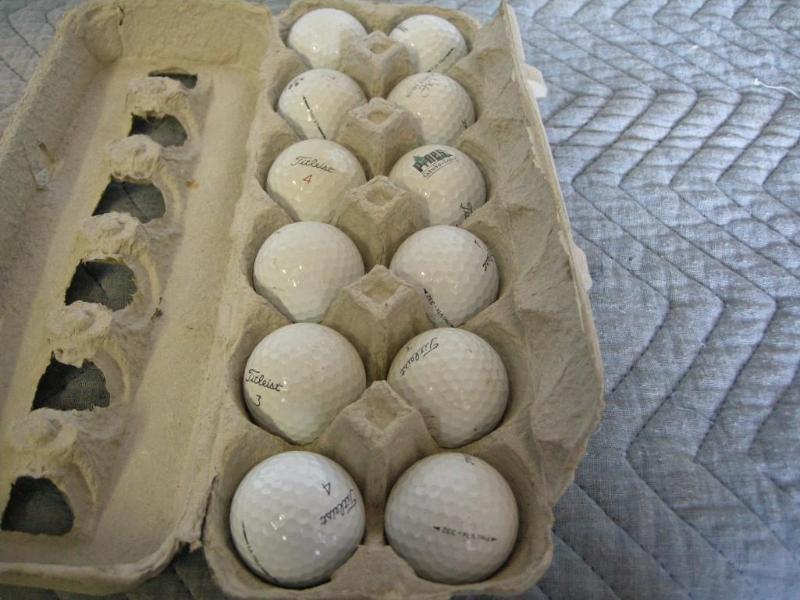 lot 99 image: 12 Titleist golf balls. Dusty but d...