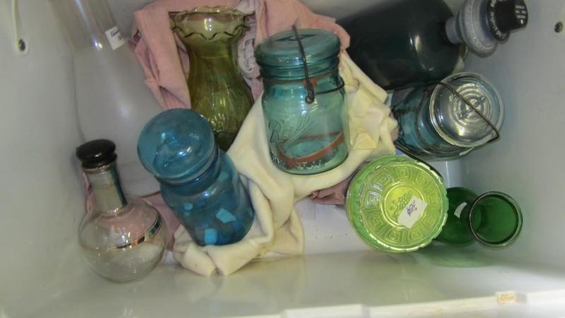 Cooler full of colored glass jars...