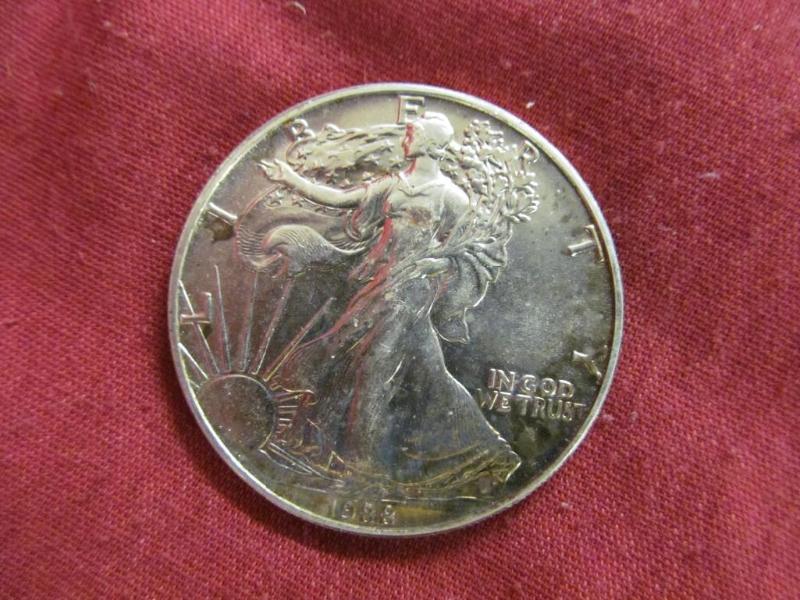 lot 44 image: 1988 Silver Eagle Dollar...