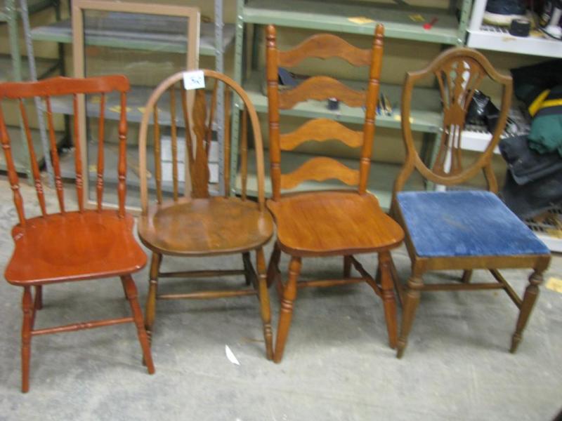 four unmatching wooden chairs all s...