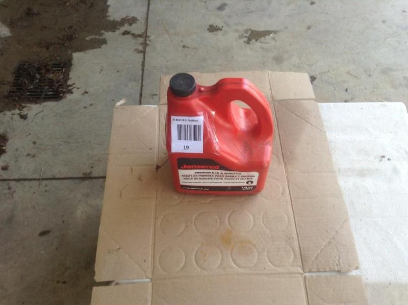 lot 19 image: Jonsered premium bar chain saw oil,...