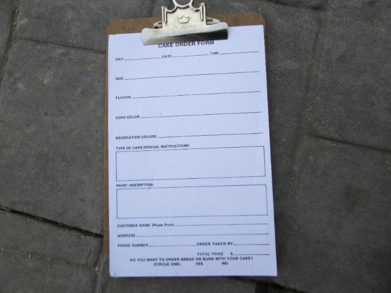 lot 51 image: Cake order form pad on clipboard...
