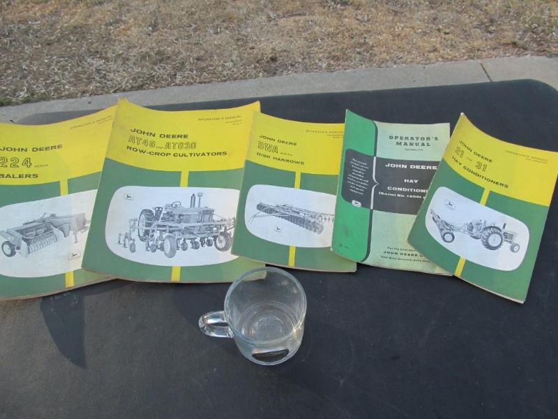 lot 100 image: J.D. manuals,along with a coffee cu...