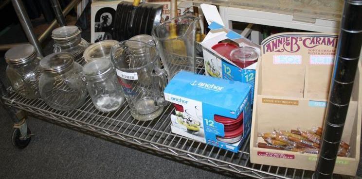 lot 29 image: Clear glass pitcher, jars and caram...