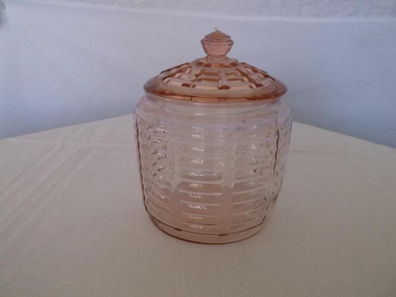 Pink depression cracker jar has a c...