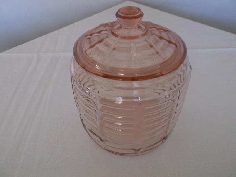Pink depression cracker jar has a c...