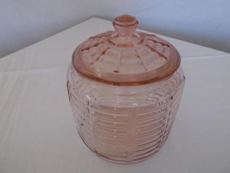 Pink depression cracker jar has a c...