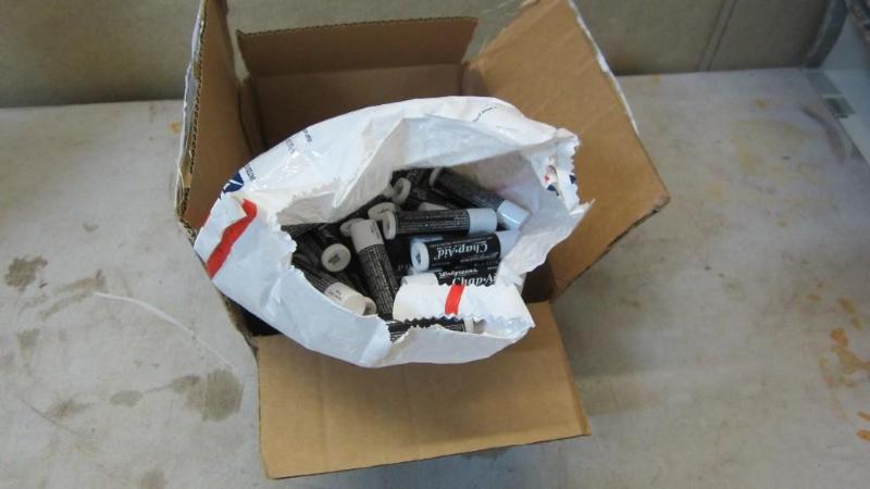 lot 89 image: Bag of new chapstick, expired dates...