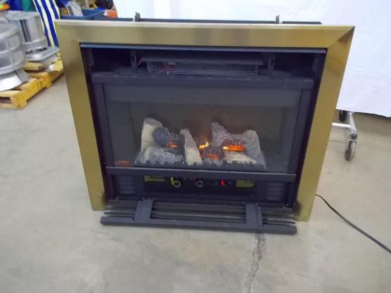 lot 1 image: Electric fireplace insert with gold...