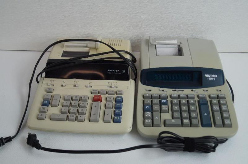 1 sharp calculator and 1 victor calculator