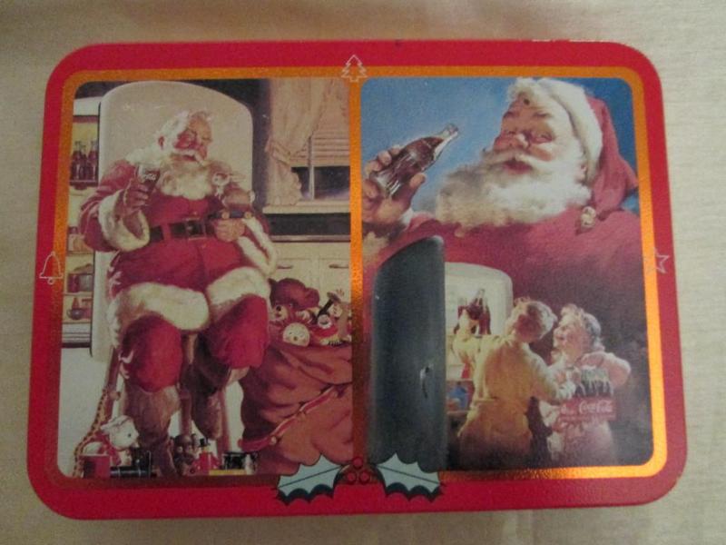 lot 142 image: Coca-Cola Christmas tin with two de...