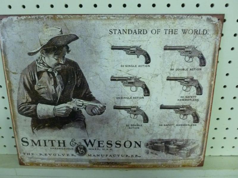 lot 48 image: Smith & Wesson metal sign that ...