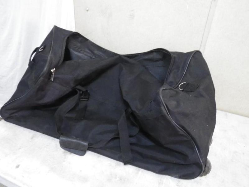 lot 104 image: large duffel with wheel on one end...