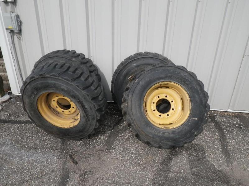 lot 8 image: Skidloader rims and tires, off New ...