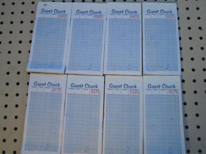 8 carbonless guest check pads...
