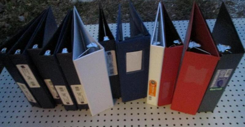 12 assorted binders...