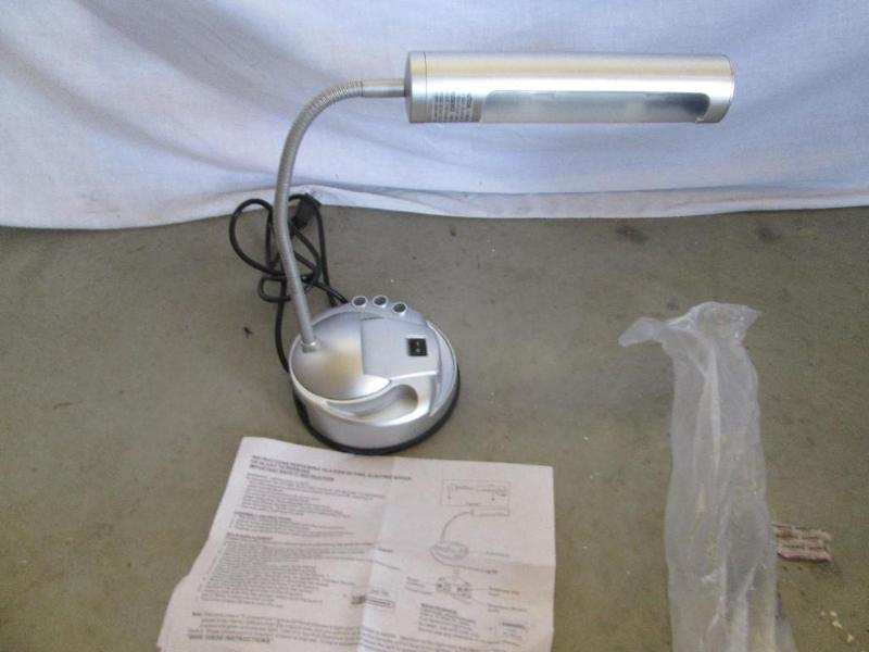 Adjustible desk lamp with pen holde...