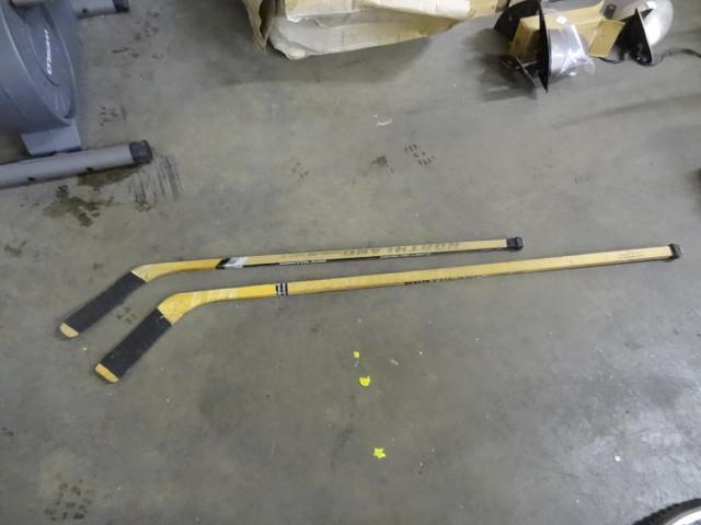 lot 121 image: 2-Wood Hockey Sticks...