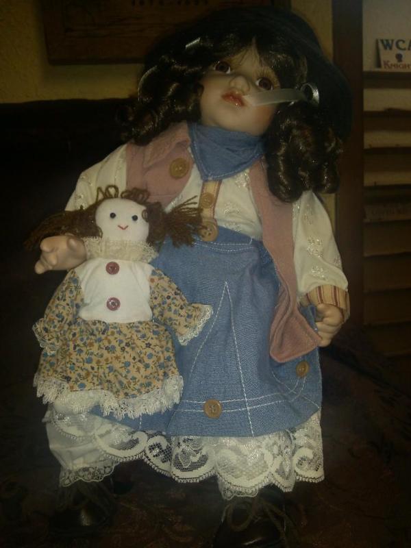 Collectable Porcelain Doll on rocke...