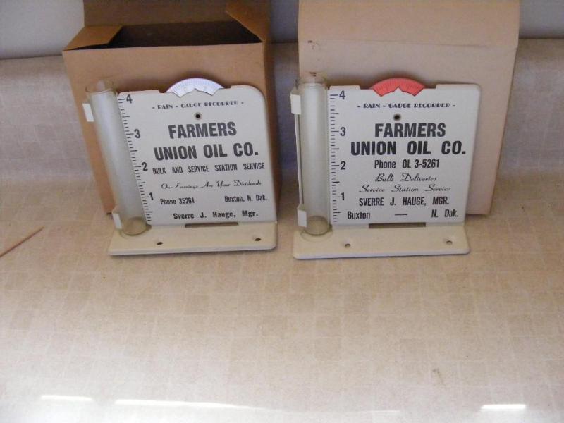 lot 58 image: two Farmers Union Oil Co Rain Gauge...
