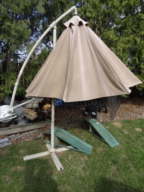 lot 28 image: Patio umbrella with stand. No holes...