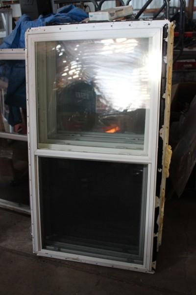 Vertical opening vinyl window with...