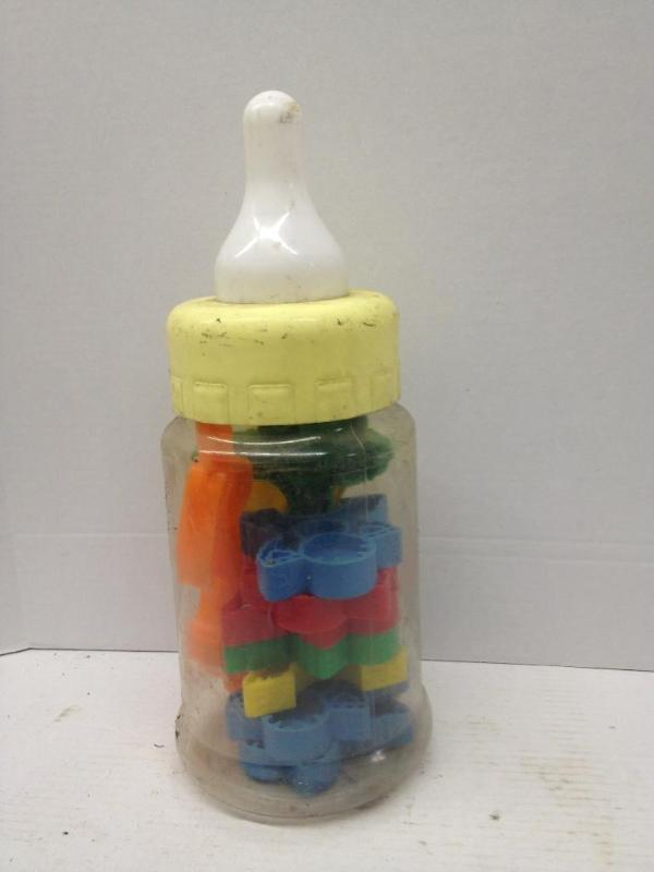 lot 93 image: Baby Bottle full of toys