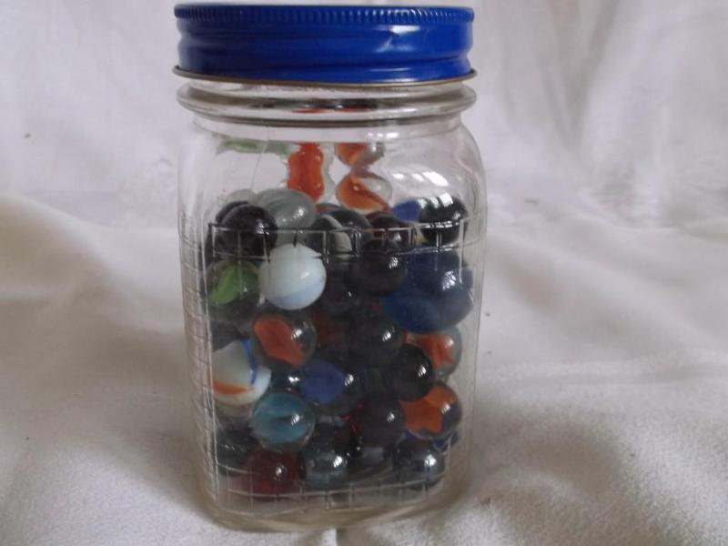 Medium size jar of marbles with som...